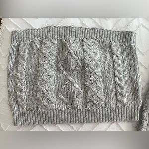 Knitted crop top with knitted crop cardigan.